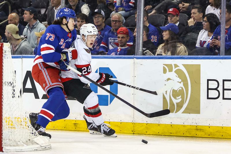 Apr 15, 2024; New York, New York, USA;  New York Rangers center Matt Rempe (73) and Ottawa Senators defenseman Jacob Bernard-Docker (24) battle for control of the puck in the first period at Madison Square Garden. Mandatory Credit: Wendell Cruz-USA TODAY Sports