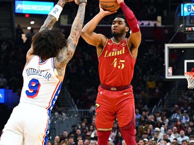 CLEVELAND, OHIO - FEBRUARY 12: Donovan Mitchell #45 of the Cleveland Cavaliers shoots over Kelly Oubre Jr. #9 of the Philadelphia 76ers during the fourth quarter at Rocket Mortgage Fieldhouse on February 12, 2024 in Cleveland, Ohio. The 76ers defeated the Cavaliers 123-121. NOTE TO USER: User expressly acknowledges and agrees that, by downloading and or using this photograph, User is consenting to the terms and conditions of the Getty Images License Agreement. (Photo by Jason Miller/Getty Images)