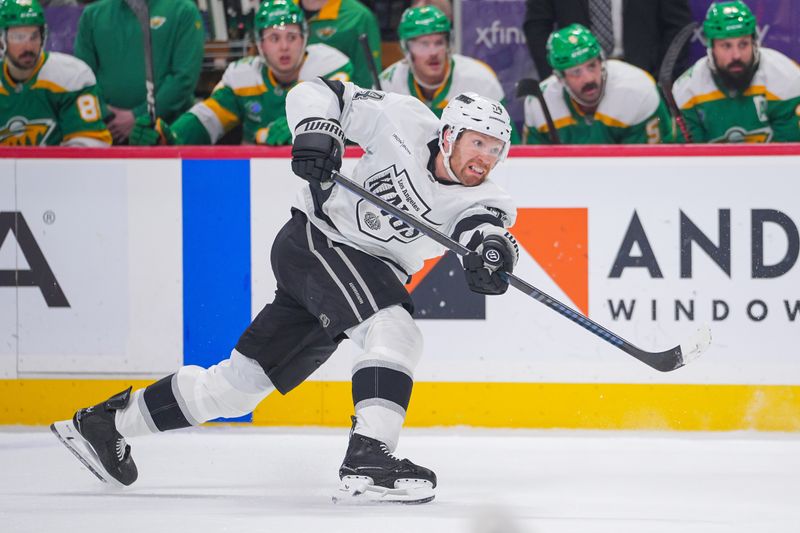Mar 17, 2025; Saint Paul, Minnesota, USA;  Los Angeles Kings defenseman Vladislav Gavrikov (84) shoots against the Minnesota Wild in the first period at Xcel Energy Center. Mandatory Credit: Brad Rempel-Imagn Images