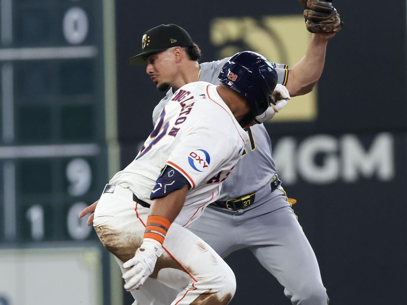 May 18, 2024; Houston, Texas, USA; Houston Astros first baseman Jon Singleton (28) is tagged out by Milwaukee Brewers shortstop Willy Adames (27) at second base trying to turn a single into a double in the second inning at Minute Maid Park. Mandatory Credit: Thomas Shea-USA TODAY Sports