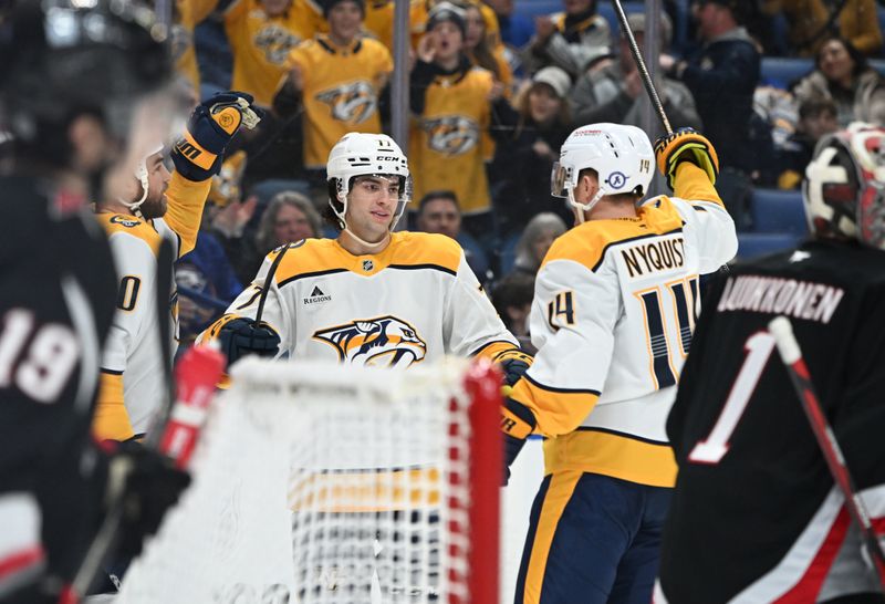 Jan 31, 2025; Buffalo, New York, USA; Nashville Predators right wing Luke Evangelista (77) is greeted by center Gustav Nyquist (14) after scoring a goal against the Buffalo Sabres in the first period at the KeyBank Center. Mandatory Credit: Mark Konezny-Imagn Images