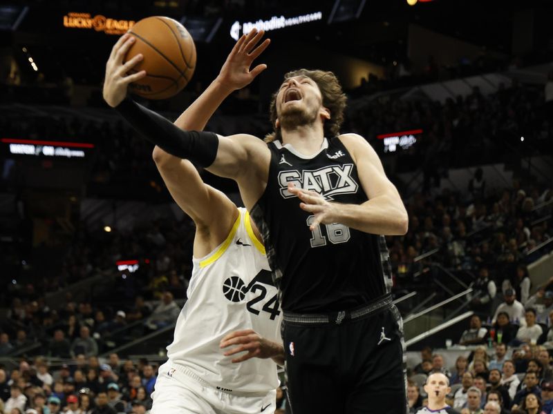 SAN ANTONIO, TX - DECEMBER 26:  Cedi Osman #16 of the San Antonio Spurs drives past Walker Kessler #24 of the Utah Jazz in the first half at Frost Bank Center on December  26, 2023 in San Antonio, Texas. NOTE TO USER: User expressly acknowledges and agrees that, by downloading and or using this photograph, User is consenting to terms and conditions of the Getty Images License Agreement. (Photo by Ronald Cortes/Getty Images)