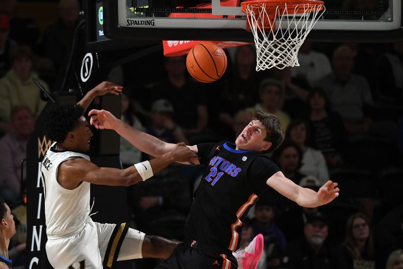 Mar 9, 2024; Nashville, Tennessee, USA; Vanderbilt Commodores guard Tyrin Lawrence (0) has his shot blocked by Florida Gators forward Alex Condon (21) during the second half at Memorial Gymnasium. Mandatory Credit: Christopher Hanewinckel-USA TODAY Sports