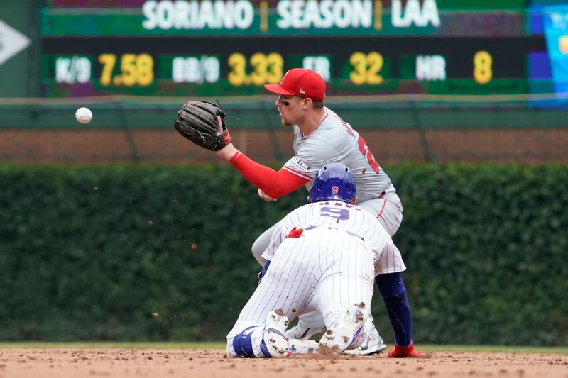 Jul 7, 2024; Chicago, Illinois, USA; Los Angeles Angels second base Brandon Drury (23) tags out Chicago Cubs catcher Miguel Amaya (9) out at second baseman during the third inning at Wrigley Field. Mandatory Credit: David Banks-USA TODAY Sports