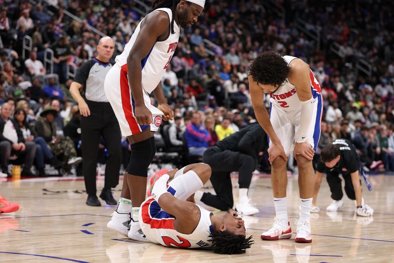 DETROIT, MICHIGAN - JANUARY 01: Jaden Ivey #23 of the Detroit Pistons reacts after being injured in the fourth quarter next to Isaiah Stewart #28 and Cade Cunningham #2 while playing the Orlando Magic at Little Caesars Arena on January 01, 2025 in Detroit, Michigan. Ivey left the court on a stretcher. NOTE TO USER: User expressly acknowledges and agrees that, by downloading and or using this photograph, User is consenting to the terms and conditions of the Getty Images License. (Photo by Gregory Shamus/Getty Images)