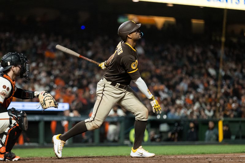 Sep 27, 2023; San Francisco, California, USA; San Diego Padres shortstop Xander Bogaerts (2) hits a sacrifice fly to drive home center fielder Trent Grisham (1) for score the go-ahead run against the San Francisco Giants  during the tenth inning at Oracle Park. Mandatory Credit: John Hefti-USA TODAY Sports