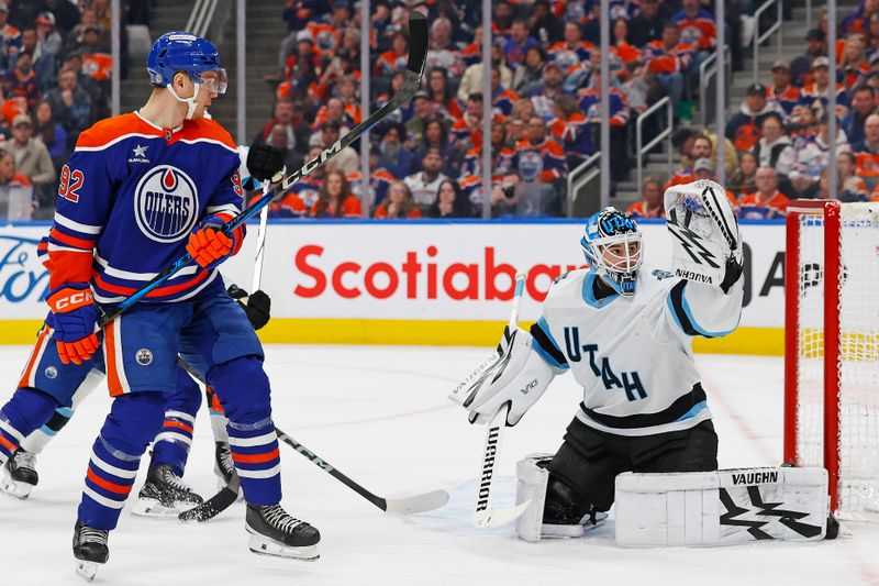 Mar 18, 2025; Edmonton, Alberta, CAN; Edmonton Oilers forward Vasily Podkolzin (92) watches a shot go wide of Utah Hockey Club goaltender Karel Vejmelka (70) during the third period at Rogers Place. Mandatory Credit: Perry Nelson-Imagn Images