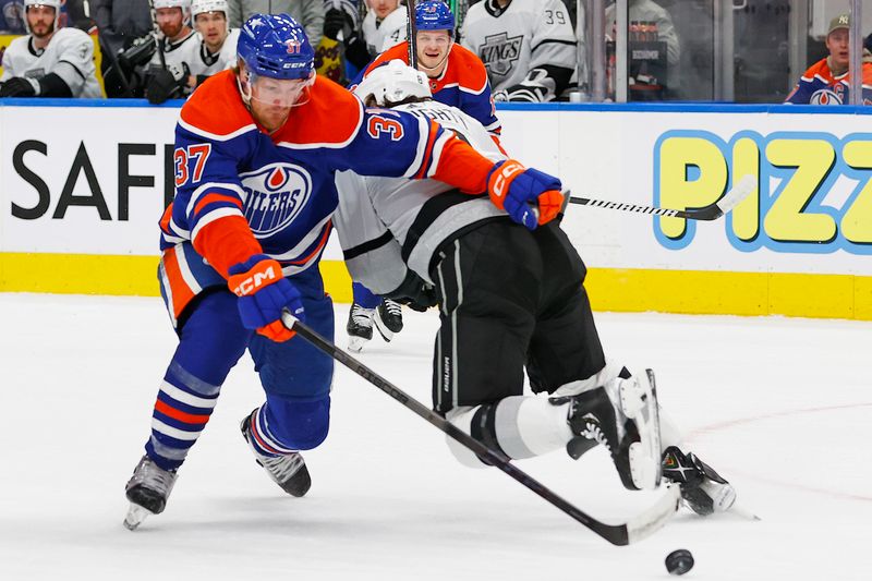 May 1, 2024; Edmonton, Alberta, CAN;Edmonton Oilers forward Warren Foegele (37) tries to carry the puck around Los Angeles Kings defensemen Drew Doughty (8) during the first period in game five of the first round of the 2024 Stanley Cup Playoffs at Rogers Place. Mandatory Credit: Perry Nelson-USA TODAY Sports