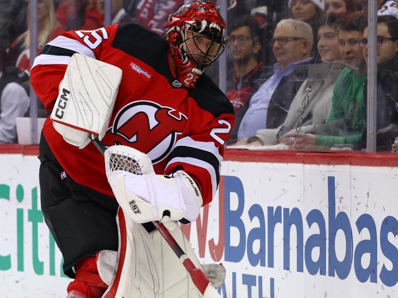 Jan 14, 2025; Newark, New Jersey, USA; New Jersey Devils goaltender Jacob Markstrom (25) plays the puck against the Florida Panthers during the first period at Prudential Center. Mandatory Credit: Ed Mulholland-Imagn Images