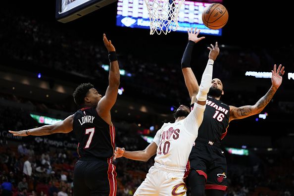 MIAMI, FLORIDA - DECEMBER 08: Caleb Martin #16 of the Miami Heat fouls Darius Garland #10 of the Cleveland Cavaliers during the first quarter at Kaseya Center on December 08, 2023 in Miami, Florida. NOTE TO USER: User expressly acknowledges and agrees that, by downloading and or using this photograph, User is consenting to the terms and condtions of the Getty Images License Agreement.  (Photo by Rich Storry/Getty Images)