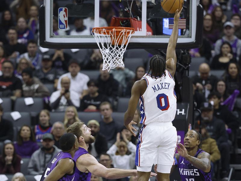 SACRAMENTO, CALIFORNIA - JANUARY 01: Tyrese Maxey #0 of the Philadelphia 76ers shoots over Domantas Sabonis #11 and DeMar DeRozan #10 of the Sacramento Kings during the first half of an NBA basketball game at Golden 1 Center on January 01, 2025 in Sacramento, California. NOTE TO USER: User expressly acknowledges and agrees that, by downloading and or using this photograph, User is consenting to the terms and conditions of the Getty Images License Agreement. (Photo by Thearon W. Henderson/Getty Images)