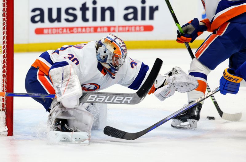 Mar 14, 2024; Buffalo, New York, USA;  New York Islanders goaltender Ilya Sorokin (30) looks to cover up the puck during the second period against the Buffalo Sabres at KeyBank Center. Mandatory Credit: Timothy T. Ludwig-USA TODAY Sports