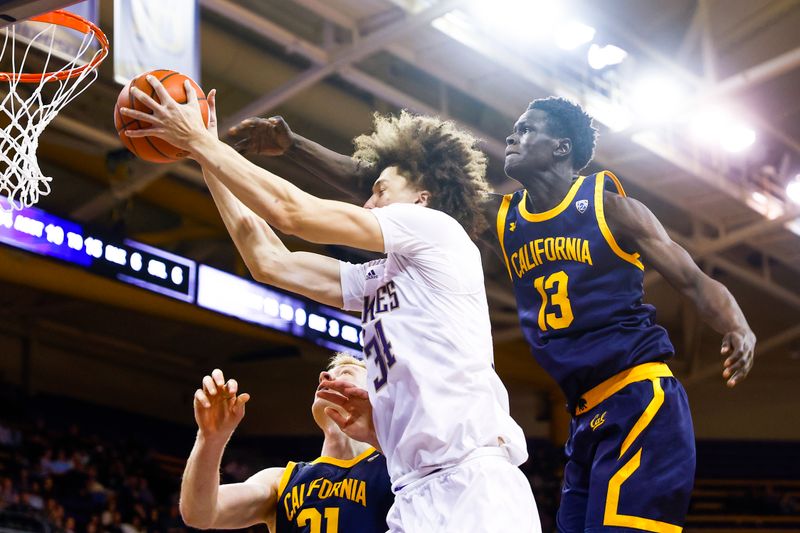 Jan 14, 2023; Seattle, Washington, USA; Washington Huskies center Braxton Meah (34) catches an entry pass between California Golden Bears forward Lars Thiemann (21) and forward Kuany Kuany (13) during overtime at Alaska Airlines Arena at Hec Edmundson Pavilion. Mandatory Credit: Joe Nicholson-USA TODAY Sports