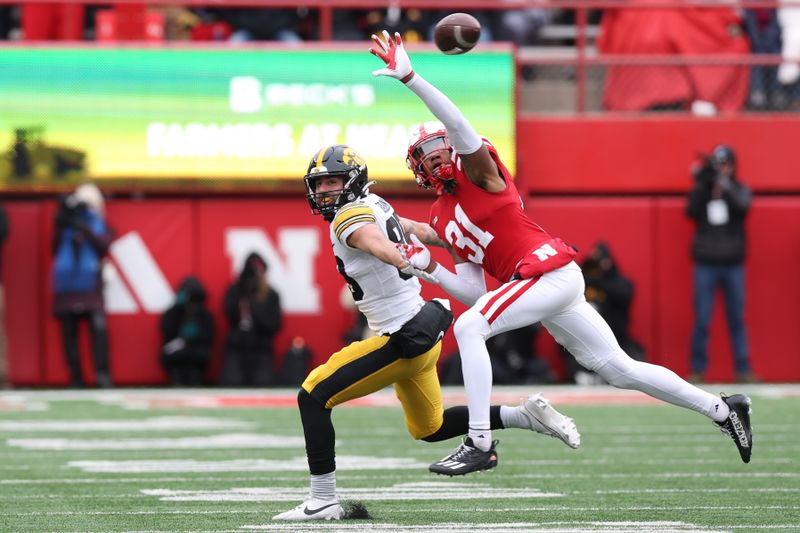 Nov 24, 2023; Lincoln, Nebraska, USA; Nebraska Cornhuskers defensive back Tommi Hill (31) blocks a pass intended for Iowa Hawkeyes wide receiver Nico Ragaini (89) at Memorial Stadium. Mandatory Credit: Reese Strickland-USA TODAY Sports