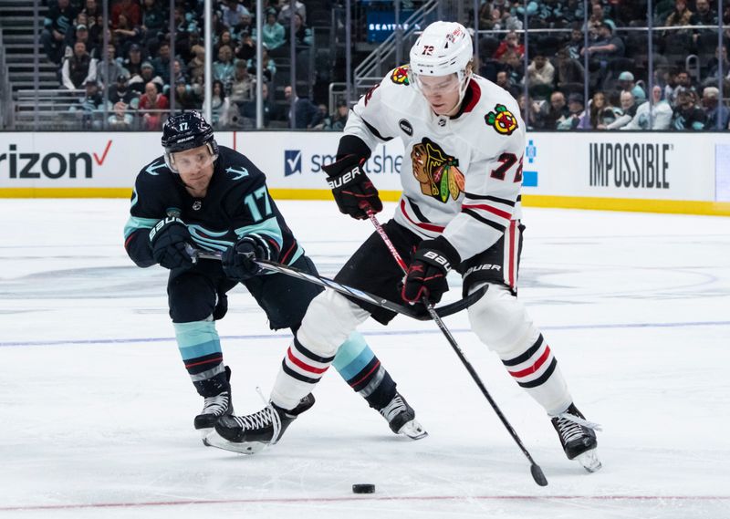 Jan 24, 2024; Seattle, Washington, USA; Seattle Kraken forward Jaden Schwartz (17) and Chicago Blackhawks defenseman Alex Vlasic (72) battle for puck during the second period at Climate Pledge Arena. Mandatory Credit: Stephen Brashear-USA TODAY Sports