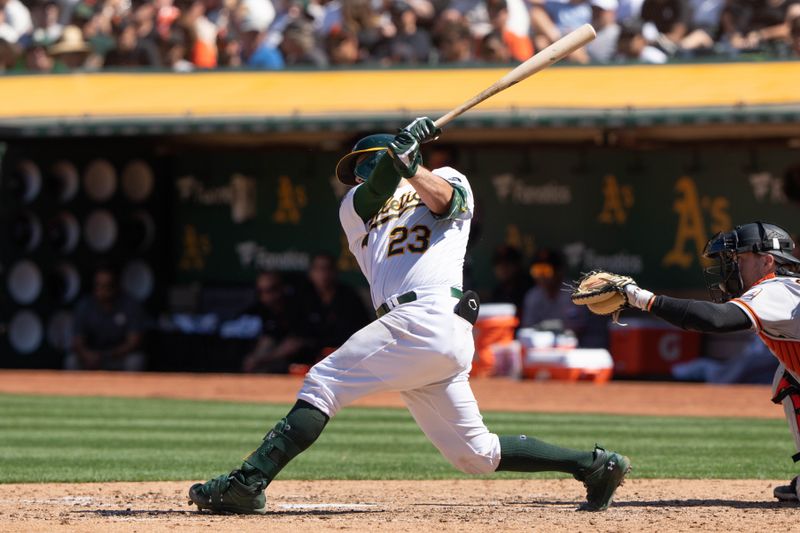 Aug 6, 2023; Oakland, California, USA;  Oakland Athletics catcher Shea Langeliers (23) hits a two-RBI single during the sixth inning against the San Francisco Giants at Oakland-Alameda County Coliseum. Mandatory Credit: Stan Szeto-USA TODAY Sports