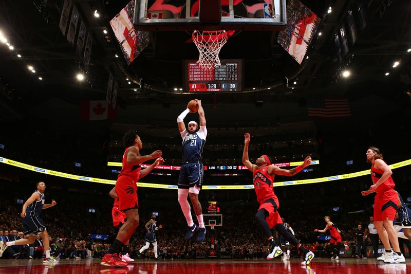 TORONTO, CANADA - FEBRUARY 28: Daniel Gafford #21 of the Dallas Mavericks rebounds the ball during the game against the Toronto Raptors on February 28, 2024 at the Scotiabank Arena in Toronto, Ontario, Canada.  NOTE TO USER: User expressly acknowledges and agrees that, by downloading and or using this Photograph, user is consenting to the terms and conditions of the Getty Images License Agreement.  Mandatory Copyright Notice: Copyright 2024 NBAE (Photo by Vaughn Ridley/NBAE via Getty Images)