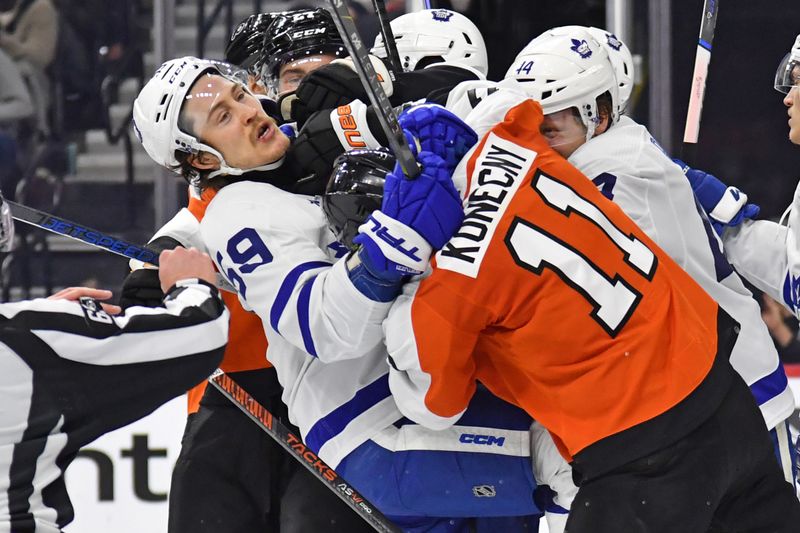 Mar 14, 2024; Philadelphia, Pennsylvania, USA; Toronto Maple Leafs left wing Tyler Bertuzzi (59) and Philadelphia Flyers right wing Travis Konecny (11) battle during the third period at Wells Fargo Center. Mandatory Credit: Eric Hartline-USA TODAY Sports