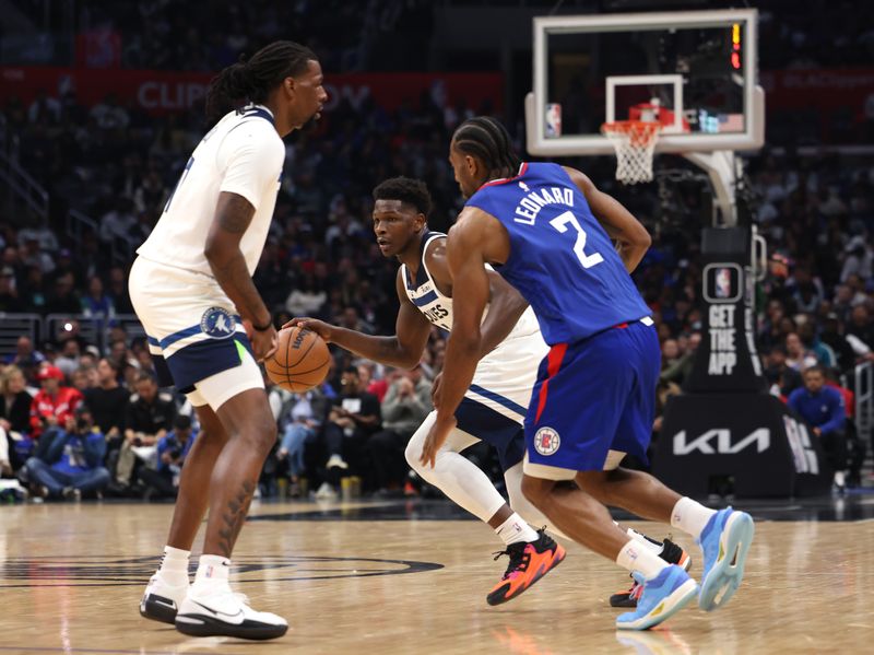 LOS ANGELES, CALIFORNIA - FEBRUARY 28: Anthony Edwards #1 of the Minnesota Timberwolves dribbles in front of Kawhi Leonard #2 of the LA Clippers and Naz Reid #11 during a 108-101 Timberwolves win at Crypto.com Arena on February 28, 2023 in Los Angeles, California. NOTE TO USER: User expressly acknowledges and agrees that, by downloading and or using this photograph, user is consenting to the terms and conditions of the Getty Images License Agreement. (Photo by Harry How/Getty Images)