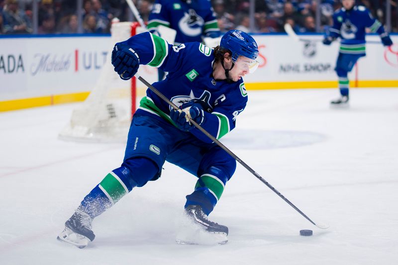 Mar 13, 2024; Vancouver, British Columbia, CAN; Vancouver Canucks defenseman Quinn Hughes (43) handles the puck against the Colorado Avalanche in the second period at Rogers Arena. Mandatory Credit: Bob Frid-USA TODAY Sports