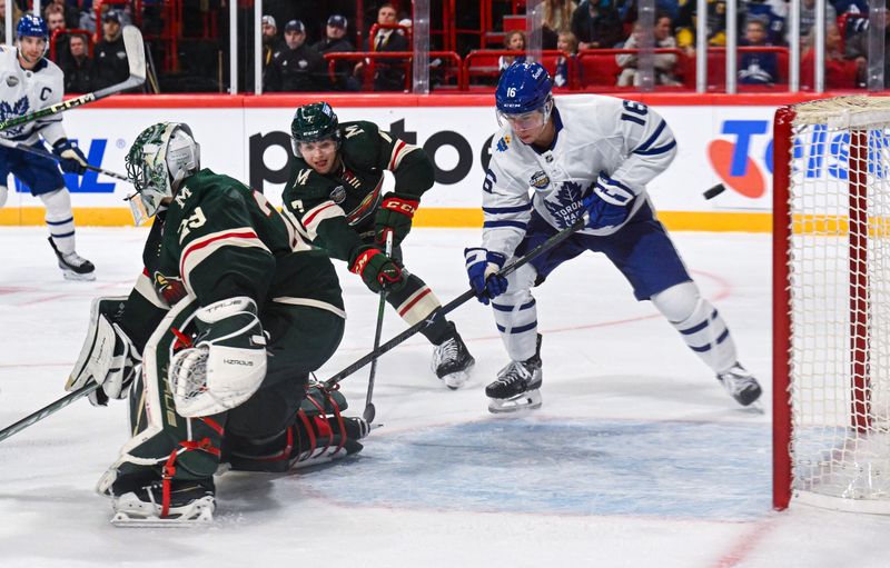 Nov 19, 2023; Stockholm, SWE; Minnesota Wild goaltender Marc-Andre Fleury (29) and Minnesota Wild defenseman Brock Faber (7) defend the net against Toronto Maple Leafs right wing Mitchell Marner (16) during a Global Series NHL hockey game at Avicii Arena. Mandatory Credit: Per Haljestam-USA TODAY Sports