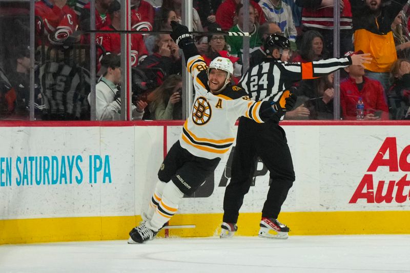 Mar 26, 2023; Raleigh, North Carolina, USA;  Boston Bruins right wing David Pastrnak (88) celebrates his goal against the Carolina Hurricanes during the first period at PNC Arena. Mandatory Credit: James Guillory-USA TODAY Sports