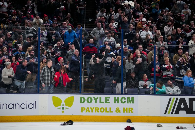 Jan 6, 2024; Columbus, Ohio, USA;  Fans throw hats onto the ice for the hat-trick goal by Columbus Blue Jackets center Cole Sillinger (4) during the game against the Minnesota Wild in the third period at Nationwide Arena. Mandatory Credit: Aaron Doster-USA TODAY Sports