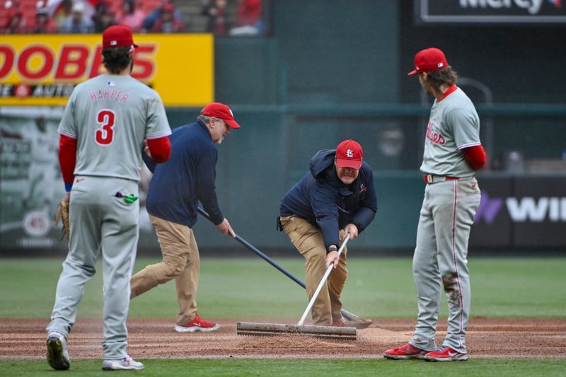 Apr 10, 2024; St. Louis, Missouri, USA;  St. Louis Cardinals grounds crew put quick dry on the field during the sixth inning of a game against the Philadelphia Phillies at Busch Stadium. Mandatory Credit: Jeff Curry-USA TODAY Sports