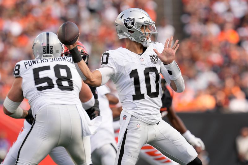 Las Vegas Raiders quarterback Desmond Ridder (10) passes against the Cincinnati Bengals during the second half of an NFL football game in Cincinnati, Sunday, Nov. 3, 2024. (AP Photo/Jeff Dean)