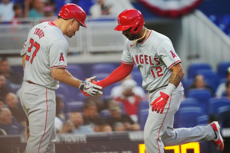 Apr 2, 2024; Miami, Florida, USA; Los Angeles Angels right fielder Aaron Hicks (12) is congratulated by center fielder Mike Trout (27) after hitting a solo home run against the Miami Marlins in the fourth inning at loanDepot Park. Mandatory Credit: Jim Rassol-USA TODAY Sports