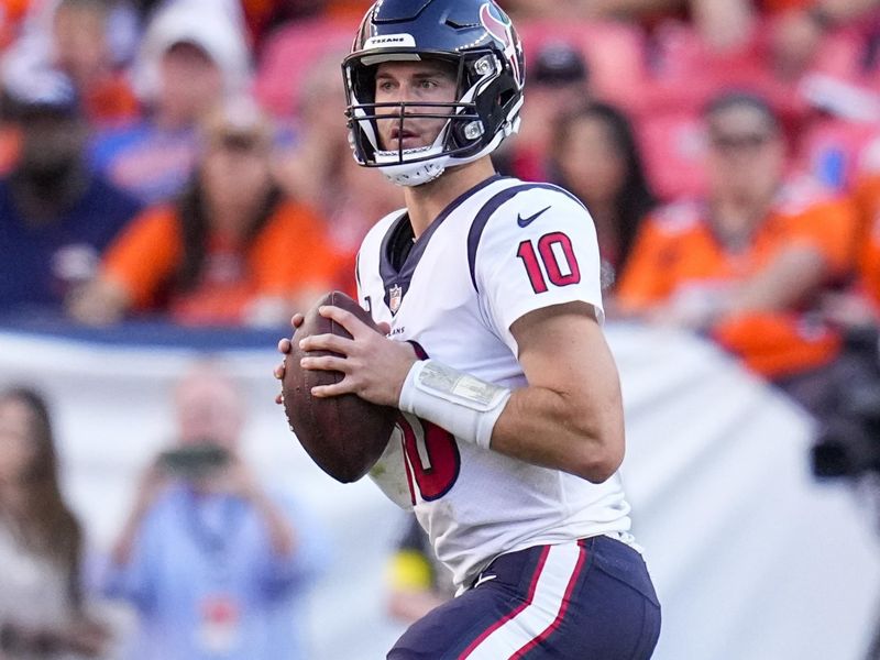 Houston Texans quarterback Davis Mills (10) drops back to pass against the Denver Broncos during an NFL football game Sunday, Sept. 18, 2022, in Denver. (AP Photo/Jack Dempsey)