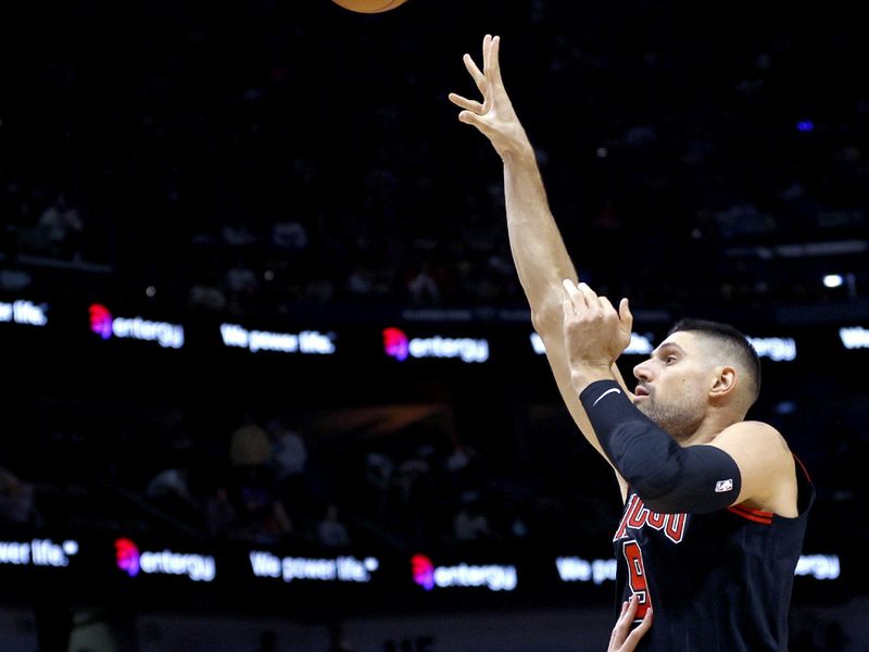 NEW ORLEANS, LOUISIANA - OCTOBER 23: Nikola Vucevic #9 of the Chicago Bulls shoots over Daniel Theis #10 of the New Orleans Pelicans during the first quarter of an NBA game at Smoothie King Center on October 23, 2024 in New Orleans, Louisiana. NOTE TO USER: User expressly acknowledges and agrees that, by downloading and or using this photograph, User is consenting to the terms and conditions of the Getty Images License Agreement. (Photo by Sean Gardner/Getty Images)