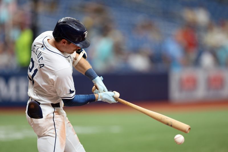 Sep 5, 2024; St. Petersburg, Florida, USA; Tampa Bay Rays outfielder Jonny DeLuca (21) hits a double against the Minnesota Twins in the seventh inning at Tropicana Field. Mandatory Credit: Nathan Ray Seebeck-Imagn Images