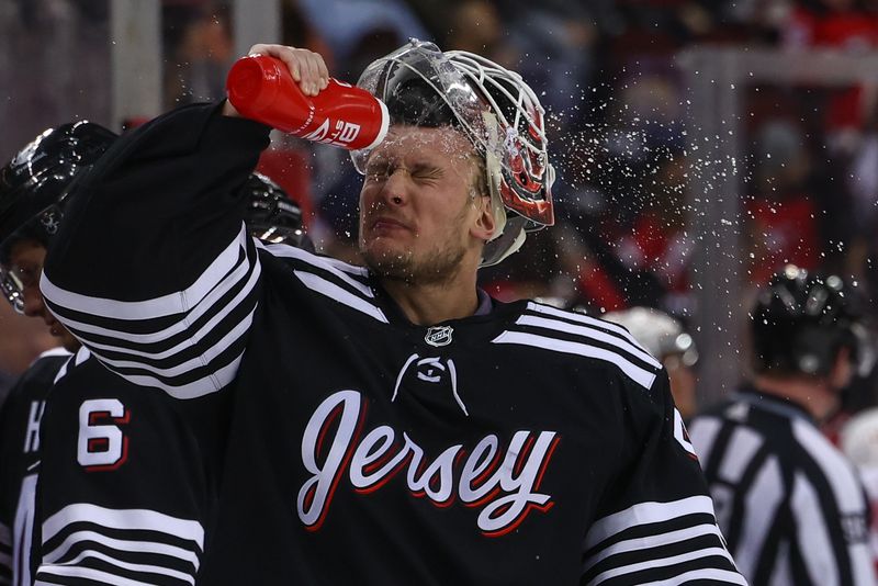 Dec 23, 2023; Newark, New Jersey, USA; New Jersey Devils goaltender Vitek Vanecek (41) sprays water on his face during a break in the first period against the Detroit Red Wings at Prudential Center. Mandatory Credit: Ed Mulholland-USA TODAY Sports