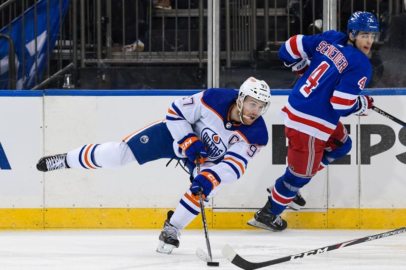 Dec 22, 2023; New York, New York, USA;  Edmonton Oilers center Connor McDavid (97) passes the puck against the New York Rangers during the third period at Madison Square Garden. Mandatory Credit: Dennis Schneidler-USA TODAY Sports