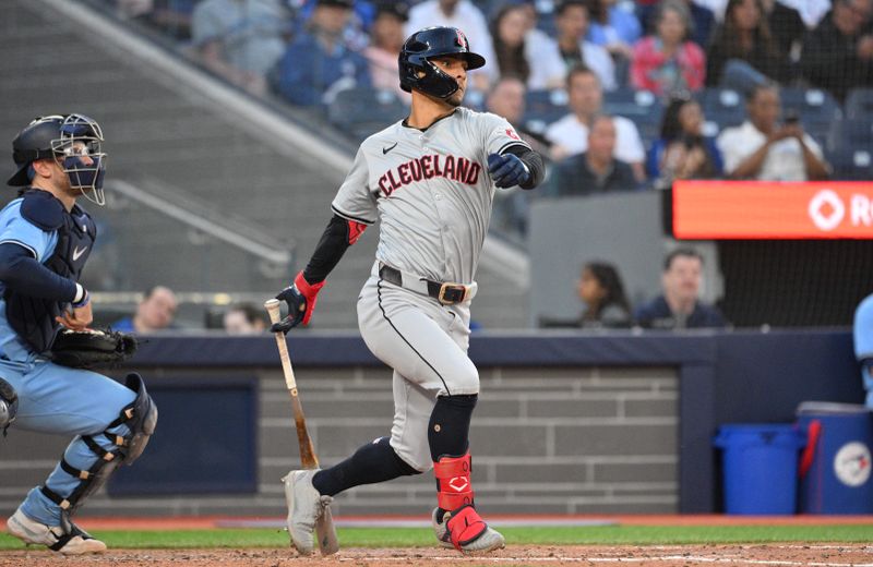 Jun 14, 2024; Toronto, Ontario, CAN;  Cleveland Indians second baseman Andres Gimenez (0) hits an RBI single against the Toronto Blue Jays in the fifth inning at Rogers Centre. Mandatory Credit: Dan Hamilton-USA TODAY Sports