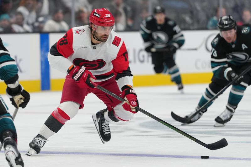 Oct 14, 2025; San Jose, California, USA;  Carolina Hurricanes left wing William Carrier (28) controls the puck during the second period against the San Jose Sharks at SAP Center at San Jose. Mandatory Credit: Stan Szeto-Imagn Images