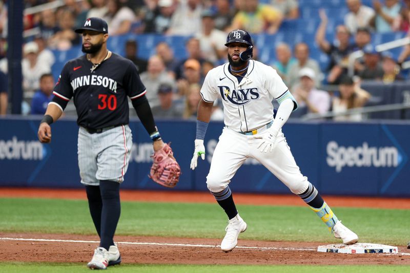 Sep 5, 2024; St. Petersburg, Florida, USA; Tampa Bay Rays third baseman Junior Caminero (13) looks on from first base after hitting a two rbi single against the Minnesota Twins in the third inning at Tropicana Field. Mandatory Credit: Nathan Ray Seebeck-Imagn Images