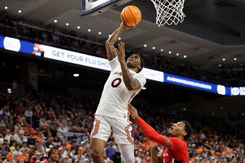 Feb 1, 2023; Auburn, Alabama, USA;  Auburn Tigers guard K.D. Johnson (0) gets past Georgia Bulldogs guard Justin Hill (11) for a shot during the second half at Neville Arena. Mandatory Credit: John Reed-USA TODAY Sports