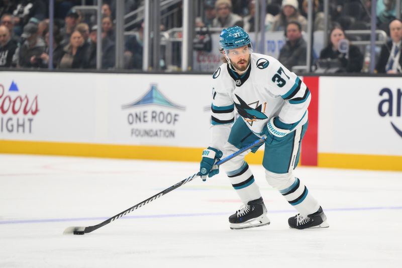 Nov 30, 2024; Seattle, Washington, USA; San Jose Sharks defenseman Timothy Liljegren (37) plays the puck during the first period against the Seattle Kraken at Climate Pledge Arena. Mandatory Credit: Steven Bisig-Imagn Images