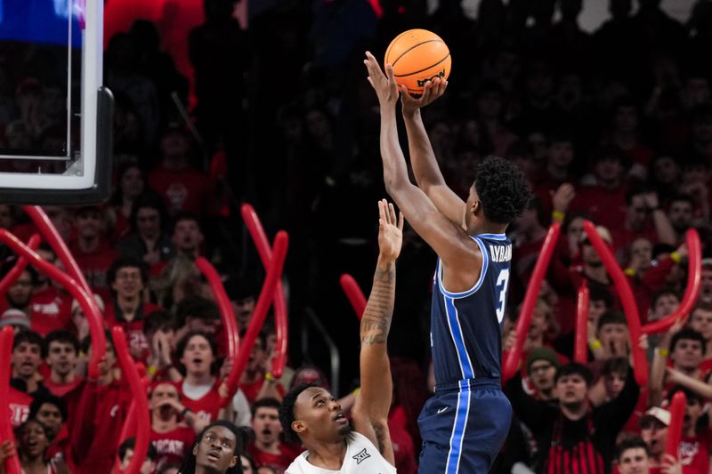 Mar 3, 2026; Cincinnati, Ohio, USA;  BYU Cougars forward AJ Dybantsa (3) shoots against Cincinnati Bearcats forward Jalen Celestine (32) in the first half at Fifth Third Arena. Mandatory Credit: Aaron Doster-Imagn Images