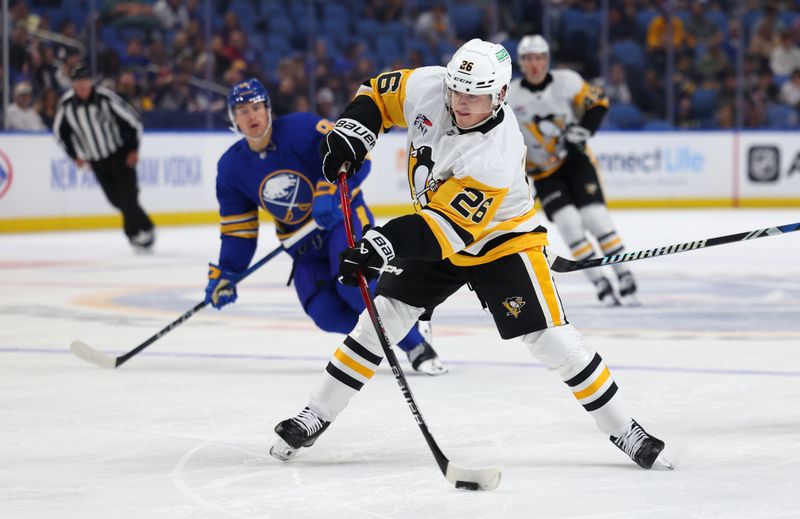 Sep 21, 2024; Buffalo, New York, USA;  Pittsburgh Penguins center Tristan Broz (26) takes a shot on goal during the first period against the Buffalo Sabres at KeyBank Center. Mandatory Credit: Timothy T. Ludwig-Imagn Images