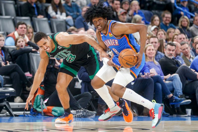 OKLAHOMA CITY, OKLAHOMA - JANUARY 03: Jalen Williams #8 of the Oklahoma City Thunder steals the ball from Malcolm Brogdon #13 of the Boston Celtics during the second quarter at Paycom Center on January 03, 2023 in Oklahoma City, Oklahoma. NOTE TO USER: User expressly acknowledges and agrees that, by downloading and or using this photograph, User is consenting to the terms and conditions of the Getty Images License Agreement.  (Photo by Ian Maule/Getty Images)