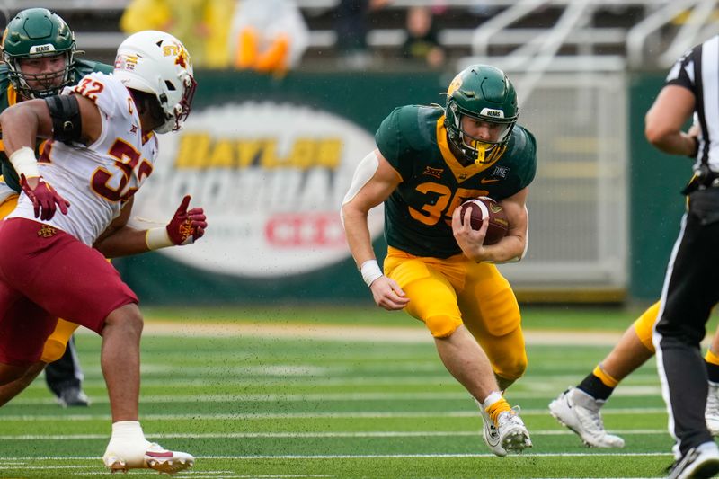 Oct 28, 2023; Waco, Texas, USA;  Baylor Bears running back Bryson Washington (30) runs the ball against Iowa State Cyclones linebacker Gerry Vaughn (32) during the first half at McLane Stadium. Mandatory Credit: Chris Jones-USA TODAY Sports