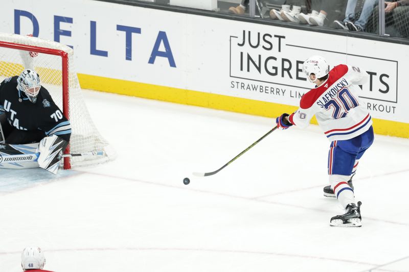 Jan 14, 2025; Salt Lake City, Utah, USA;  Montreal Canadiens left wing Juraj Slafkovsky (20) shoots the puck against the Utah Hockey Club during the second period at Delta Center. Mandatory Credit: Chris Nicoll-Imagn Images