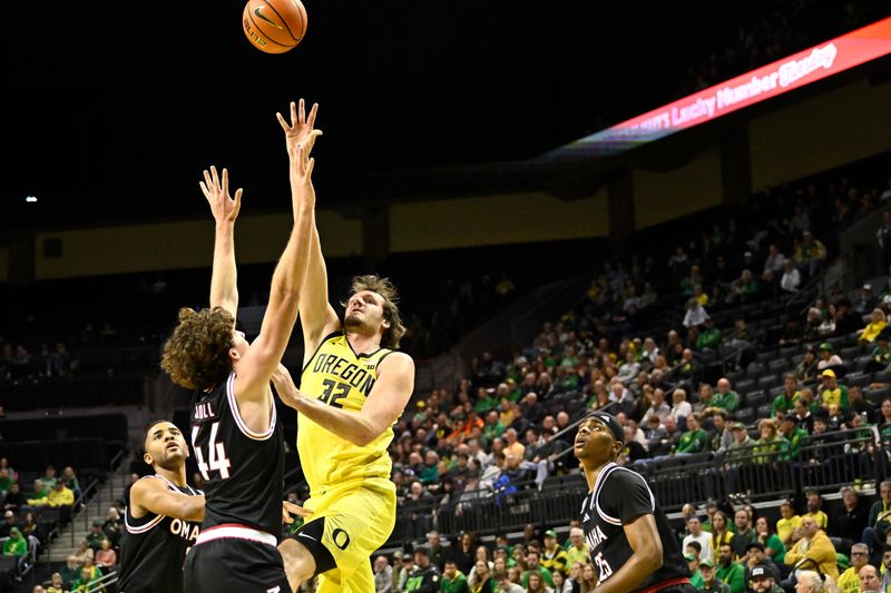 Dec 28, 2025; Eugene, Oregon, USA; Oregon Ducks center Nate Bittle (32) shoots the ball over Omaha Mavericks forward Brock Scholl (44) during the first half at Matthew Knight Arena. Mandatory Credit: Craig Strobeck-Imagn Images
