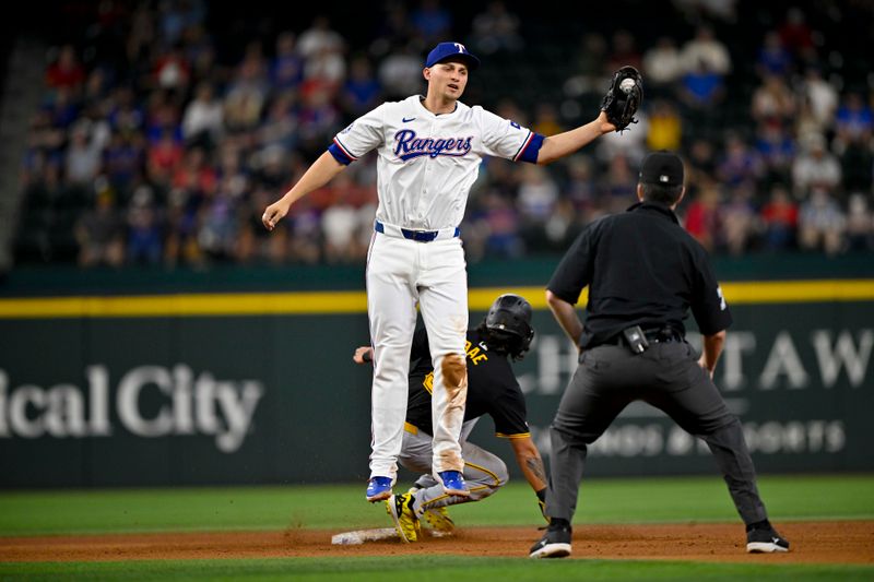 Aug 21, 2024; Arlington, Texas, USA; Pittsburgh Pirates pinch runner Ji-hwan Bae (3) slides past Texas Rangers shortstop Corey Seager (5)  during the eighth inning against the Texas Rangers at Globe Life Field. Mandatory Credit: Jerome Miron-USA TODAY Sports