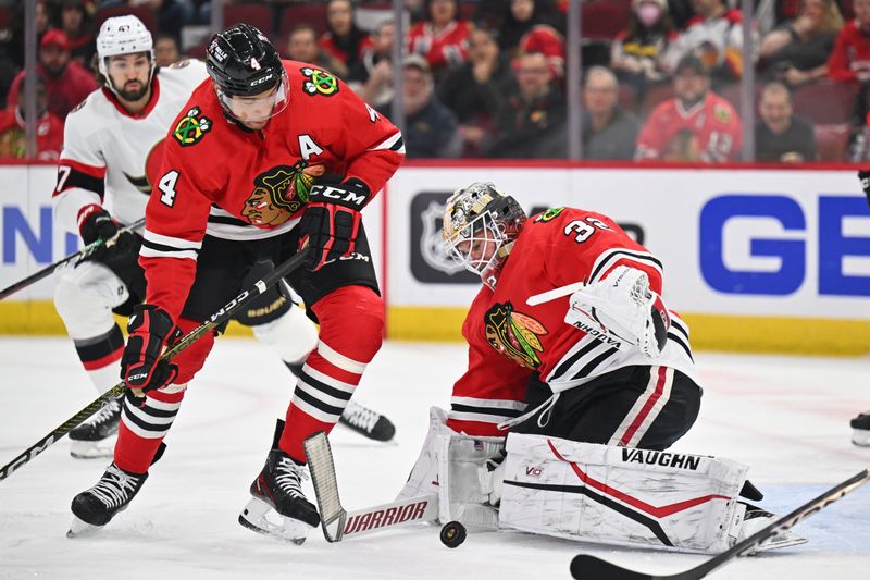 Mar 6, 2023; Chicago, Illinois, USA;  Chicago Blackhawks defenseman Seth Jones (4) and goaltender Alex Stalock (32) follow the puck after a shot on goal from the Ottawa Senators in the first period at United Center. Mandatory Credit: Jamie Sabau-USA TODAY Sports