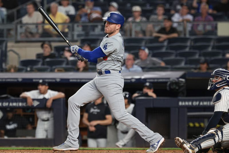 Jun 8, 2024; Bronx, New York, USA; Los Angeles Dodgers first baseman Freddie Freeman (5) hits a two run double during the ninth inning against the New York Yankees at Yankee Stadium. Mandatory Credit: Vincent Carchietta-USA TODAY Sports