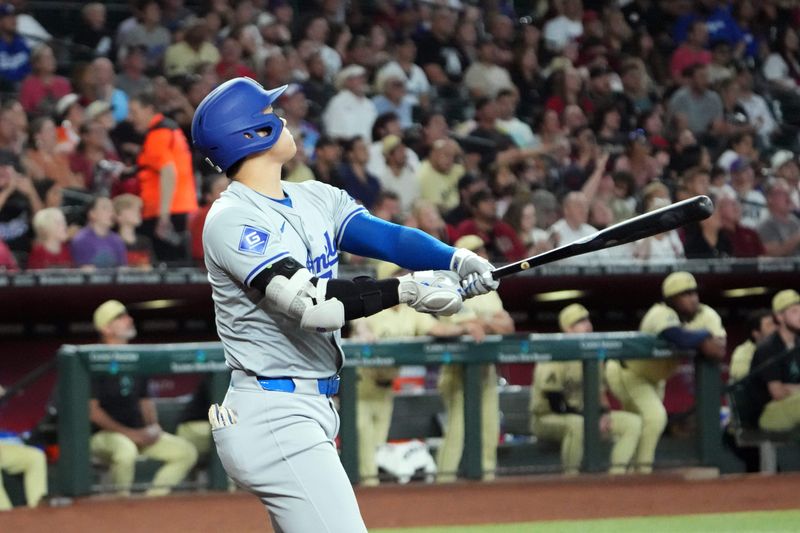 Aug 31, 2024; Phoenix, Arizona, USA; Los Angeles Dodgers two-way player Shohei Ohtani (17) hits a solo home run against the Arizona Diamondbacks during the first inning at Chase Field. Mandatory Credit: Joe Camporeale-USA TODAY Sports
